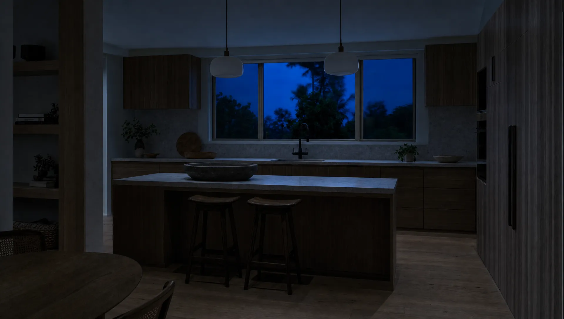 A kitchen at dusk with every light off