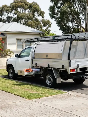 The crew's white ute with a ladder rack